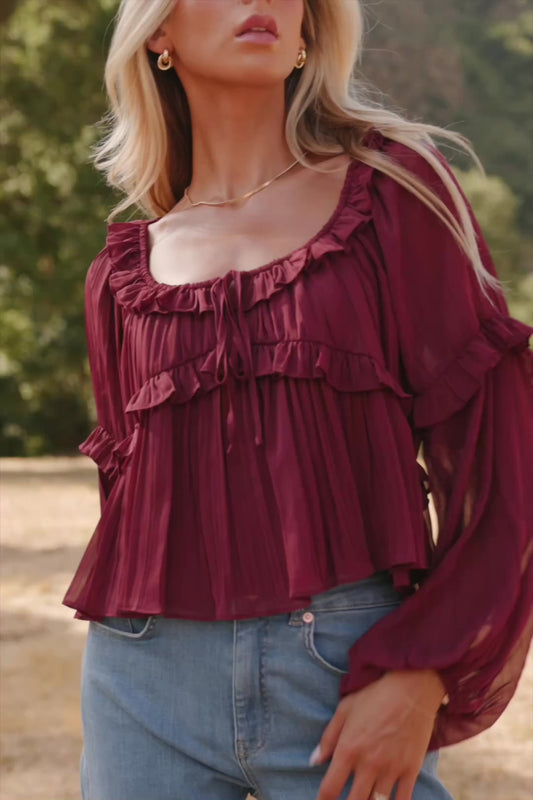 Bellerose Ruffle Top in Burgundy with pleated chiffon, ruffle-trimmed neckline, front tie, and billowy long sleeves.