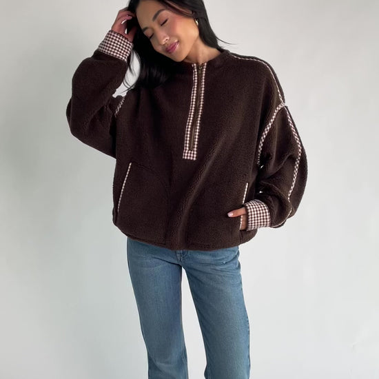 Tylee Fleece Jacket in Chocolate with sherpa fleece, half-zip neckline, brown gingham trim, fold-over cuffs, and side pockets.