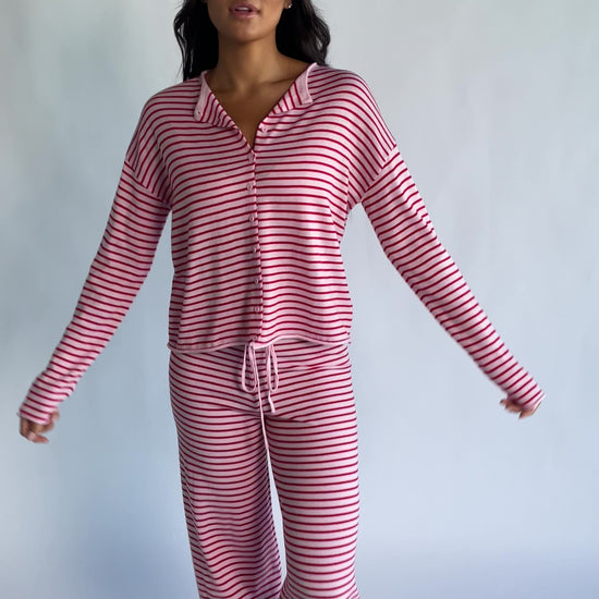 Charlene Cozy Stripe Lounge Set in Pink + Red with striped pattern and coordinating top and pants.