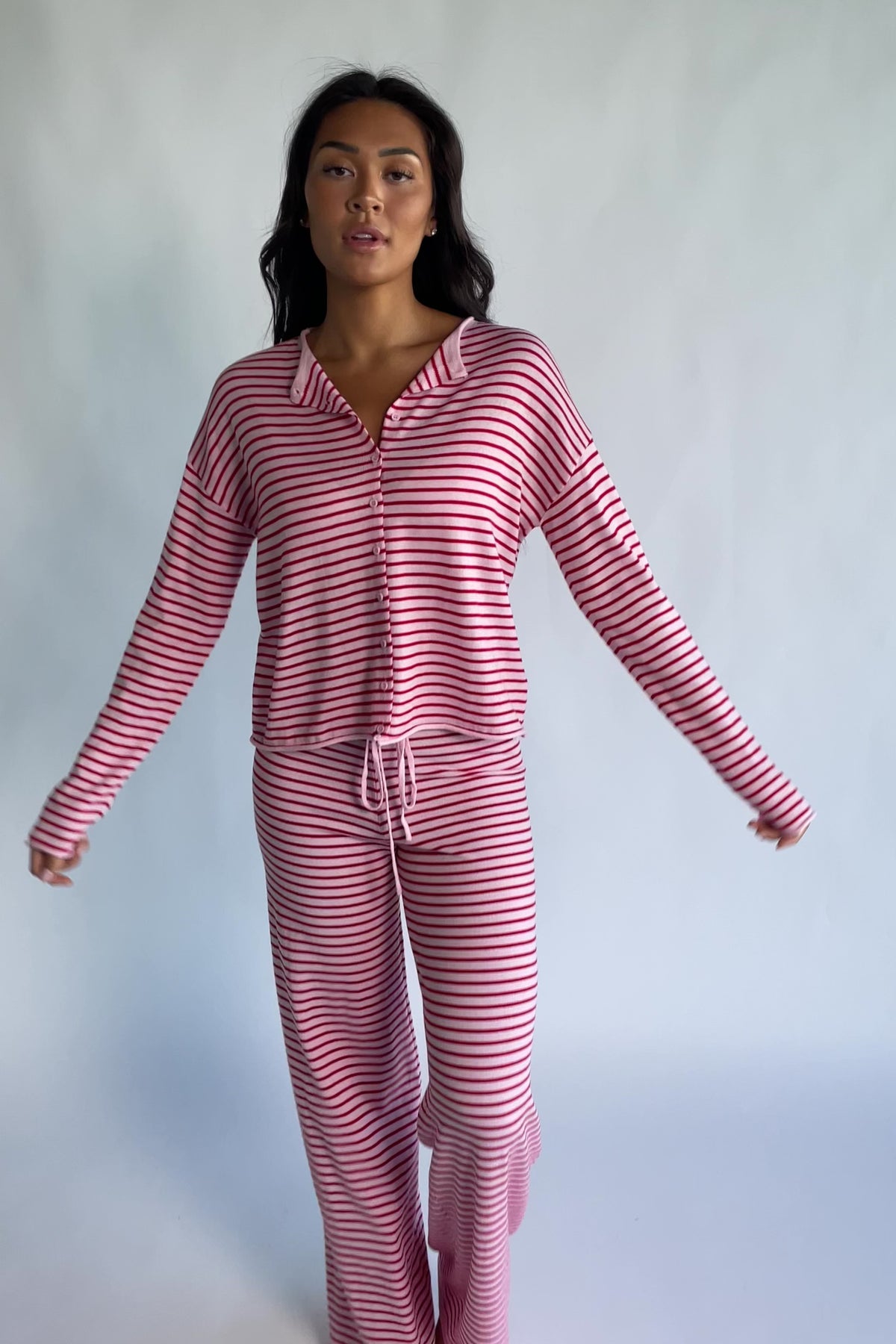 Charlene Cozy Stripe Lounge Set in Pink + Red with striped pattern and coordinating top and pants.