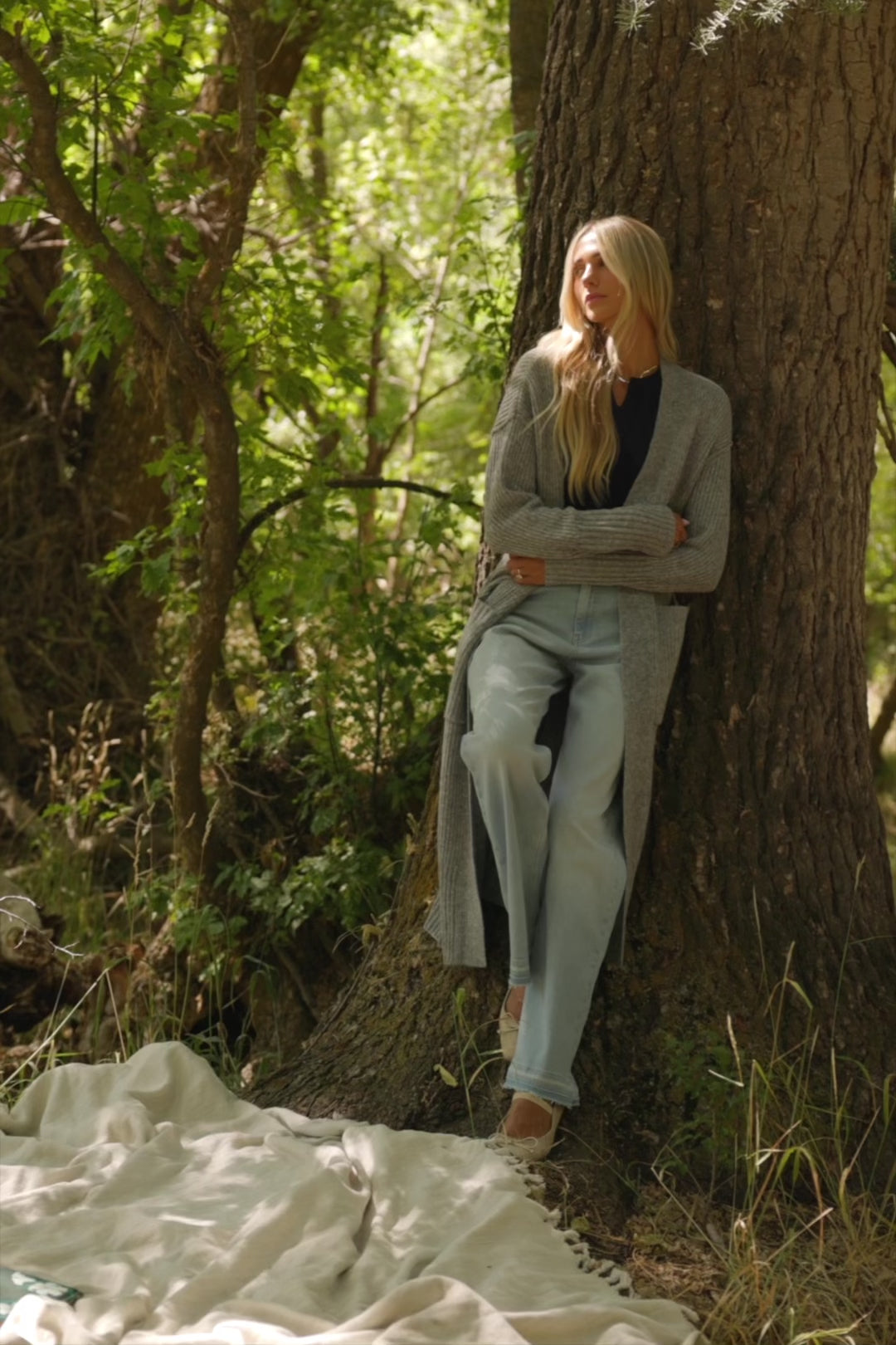 Bria High Rise Wide Leg Jeans in Light Wash with relaxed wide legs, front and back pockets, button closure, and raw hem.