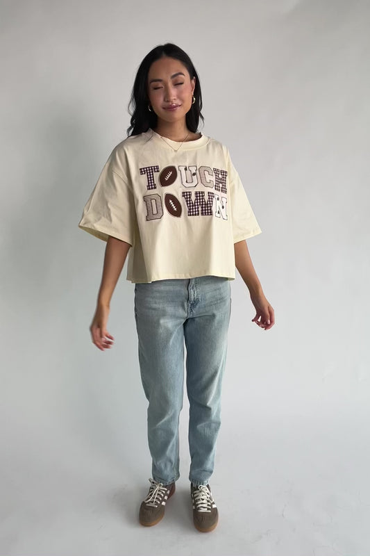 Jason Graphic Tee in Cream with vintage football graphic, gingham, lace and bow appliqué, crew neckline, and short sleeves.