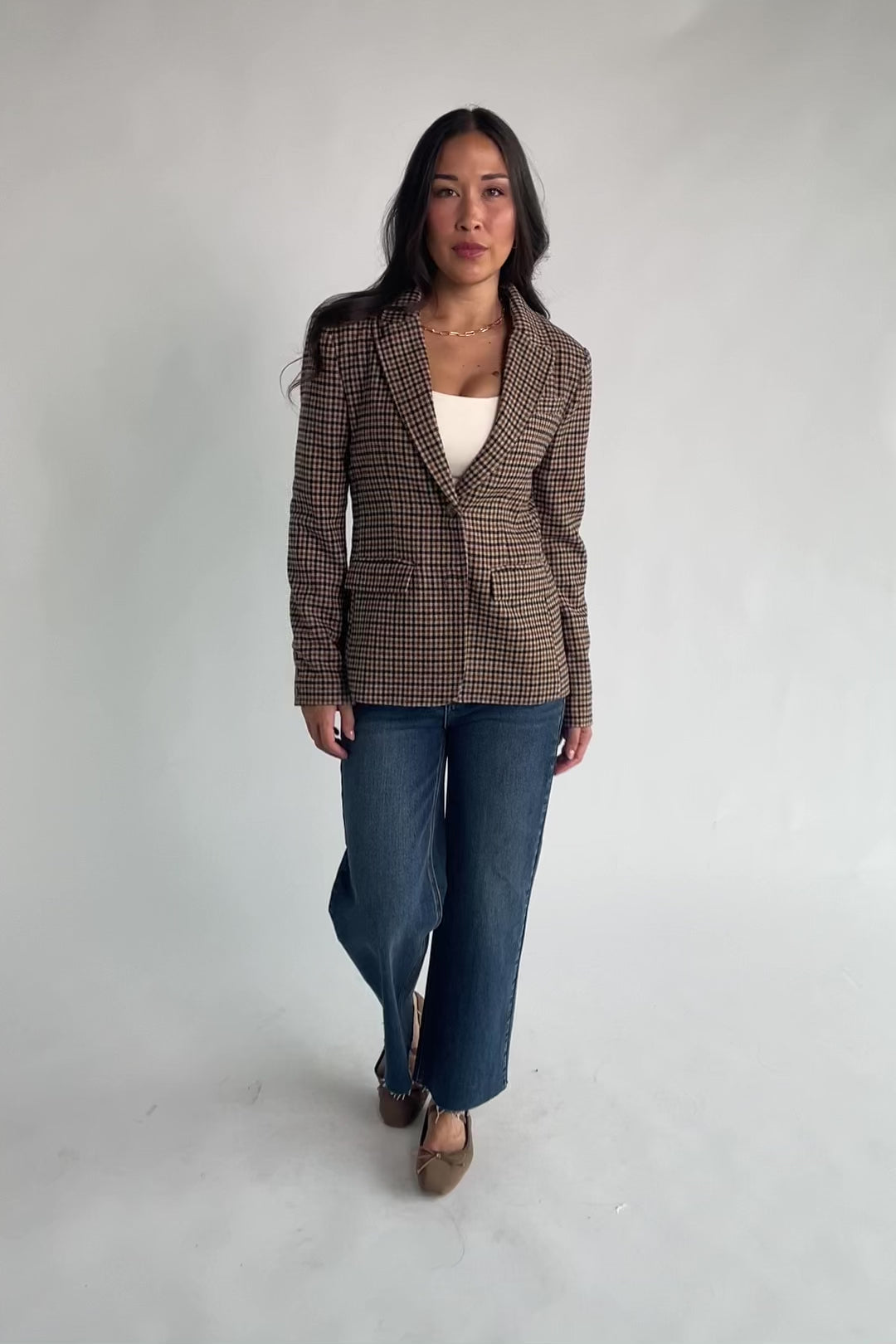 Damien Plaid Blazer in black and camel plaid with tailored waist, two-button front, flap pockets, and long sleeves.