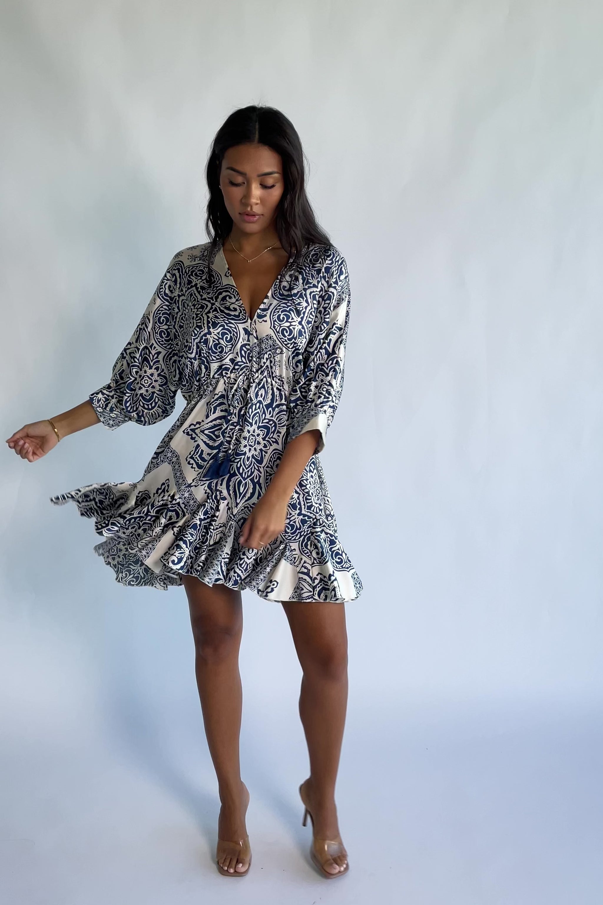 Morwen Short Dress in Navy Print with a V-neckline front and back, batwing sleeves, and a ruffled paneled skirt.