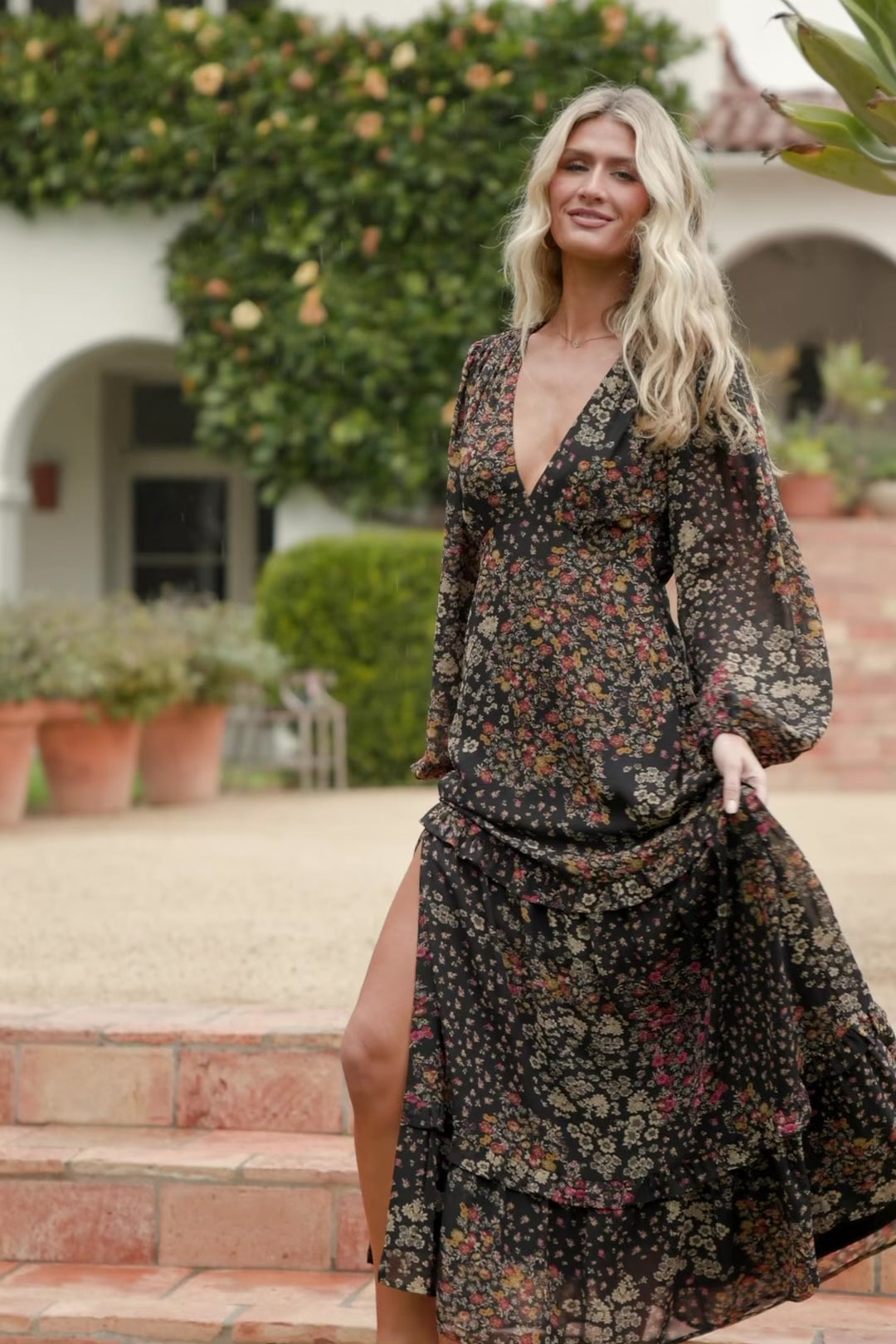 Bowman Deep V Tiered Maxi Dress in Black Multi with deep V-neck, long sleeves, ruffle-tiered skirt, and leg slit.