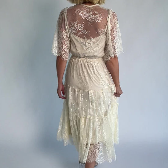 Brittany Lace Midi Dress in Vintage Cream with deep V-neck, sheer lace sleeves, elastic waist, and tiered skirt.