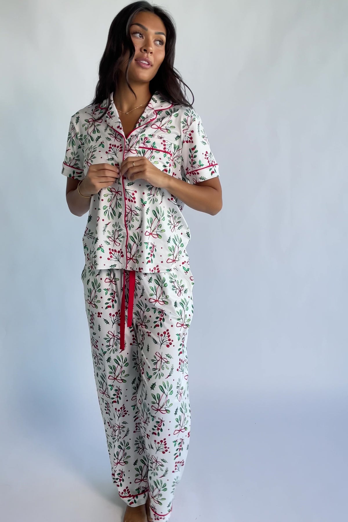 Mistletoe Cozy Pajama Set in Ivory Multi with a festive mistletoe and holly print, button-front top, and contrast piping.