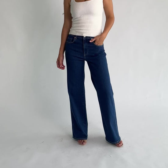 Vesper Mid Rise Wide Leg Jeans in Dark Wash with relaxed wide legs, mid-rise waist, button and zipper closure.