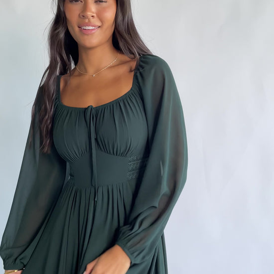 Maddalena Maxi Dress in Dark Green with a sweetheart neckline, embroidered chevron detailing, and long sheer sleeves.