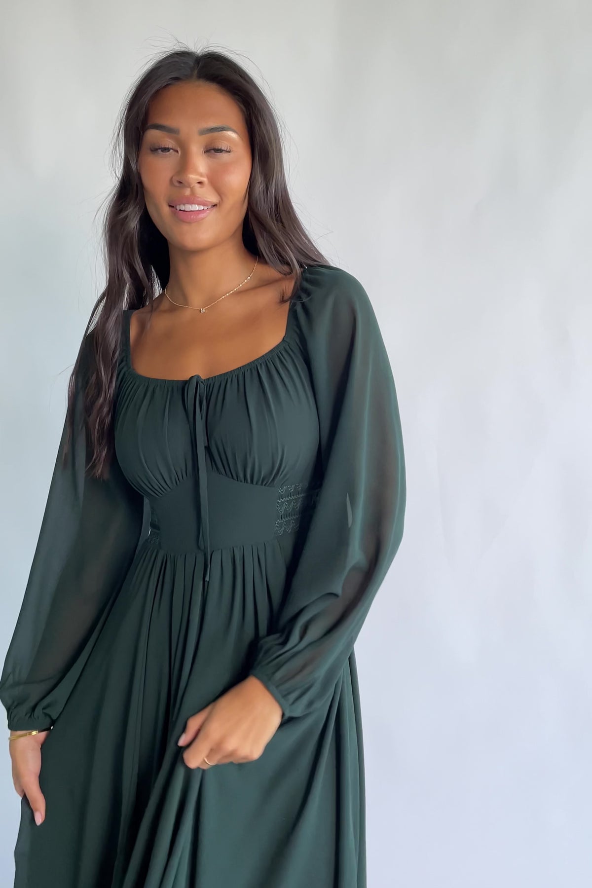 Maddalena Maxi Dress in Dark Green with a sweetheart neckline, embroidered chevron detailing, and long sheer sleeves.