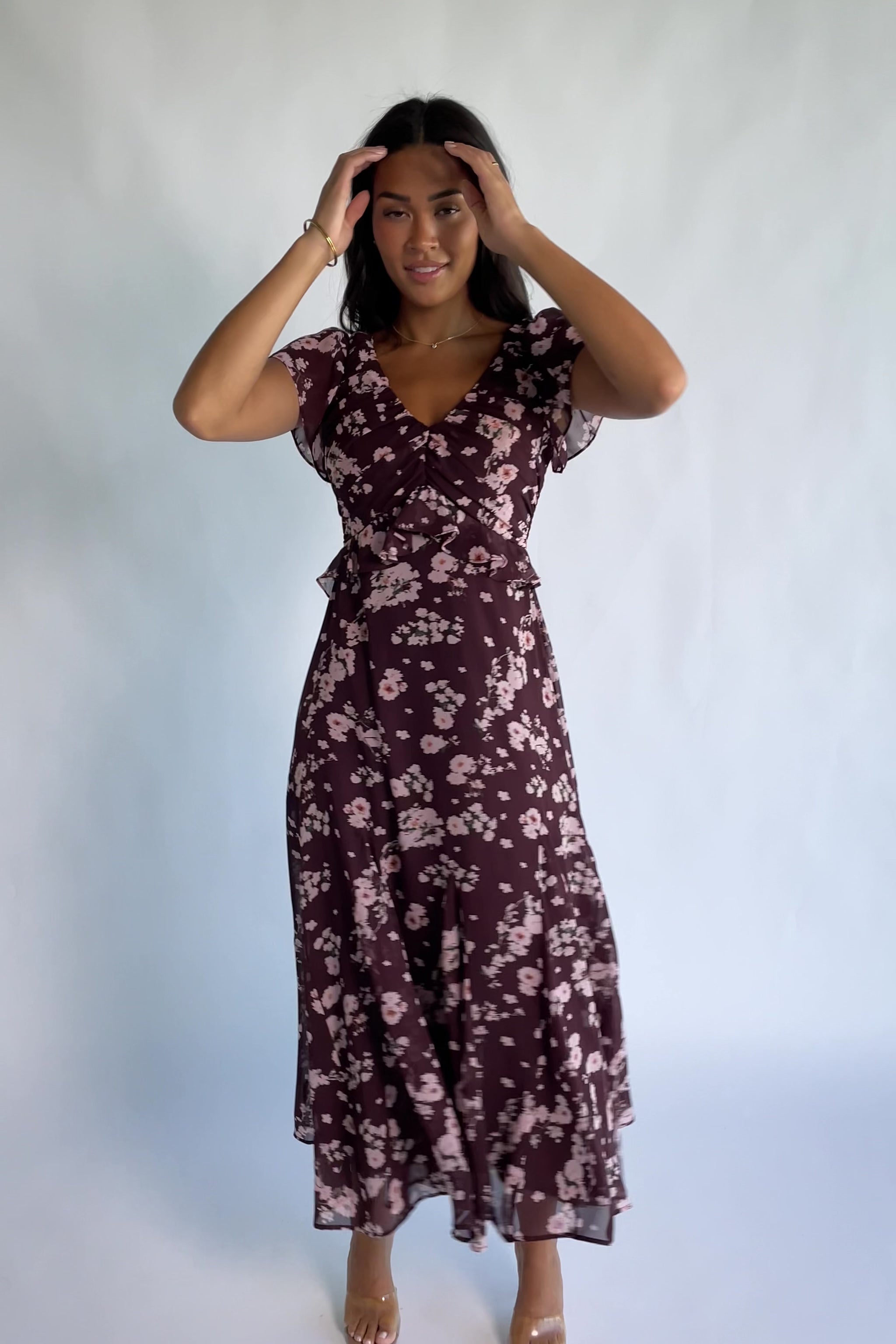 Teuila Midi Dress in Dark Clove + Blush Floral with V-neckline, ruched bust, flutter sleeves, and ruffle skirt.
