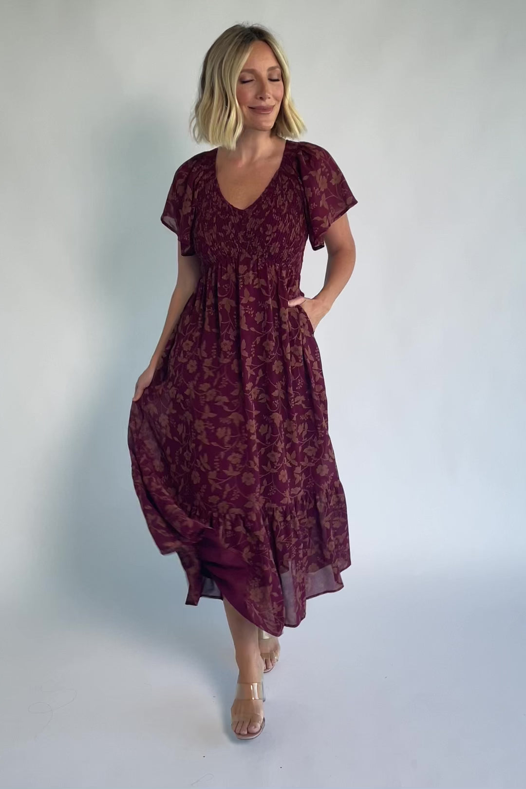 Monica Smocked Dress in Wine + Gold with V-neckline, smocked bodice, flutter sleeves, high waist, and tiered skirt.