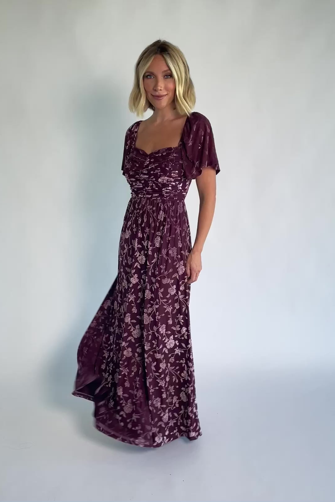 Veloura Maxi Dress in Mulberry Floral with sweetheart neckline, flutter sleeves, ruched bust, smocked back, and velvet florals.