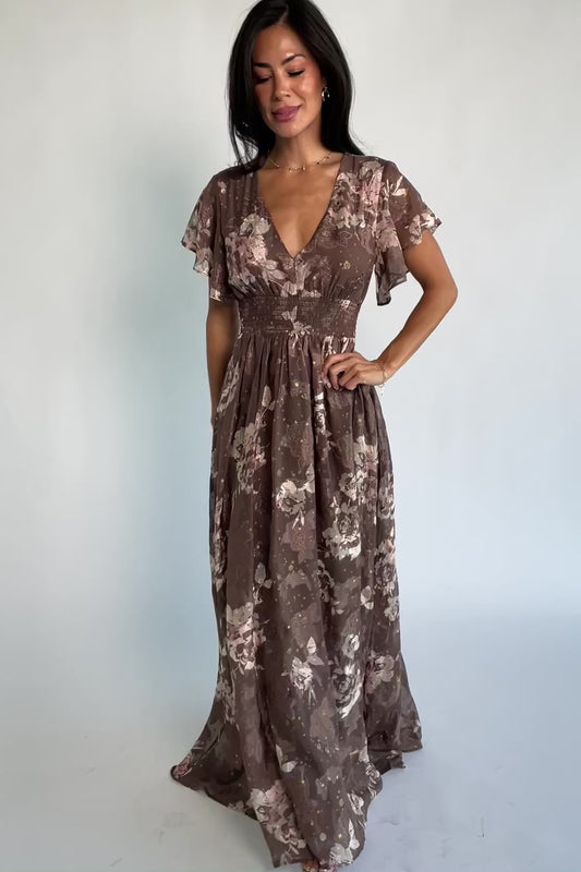 Mocha metallic floral chiffon maxi dress with a V-neckline, flutter sleeves, smocked waist, and flowing full-length skirt.