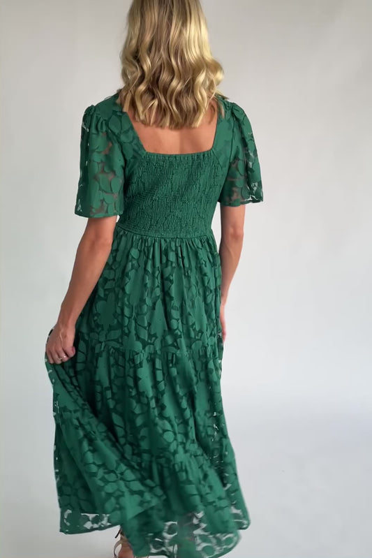 Floral lace midi dress with a deep V-neckline, short flutter sleeves, smocked back bodice, defined waistband, and tiered skirt.