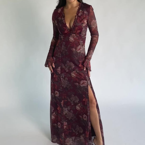 Julietta Maxi Dress in Mahogany Rose Floral with plunging V-neck, sheer long sleeves, ruffle trim, and leg slit.