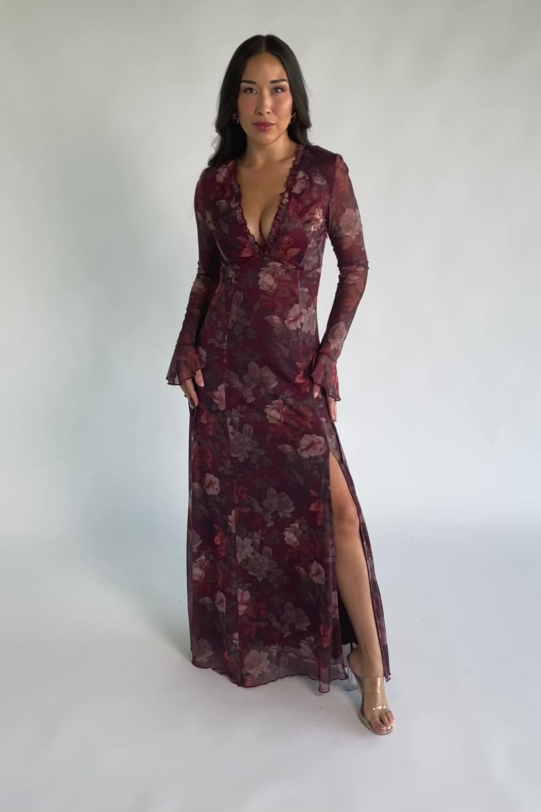 Julietta Maxi Dress in Mahogany Rose Floral with plunging V-neck, sheer long sleeves, ruffle trim, and leg slit.