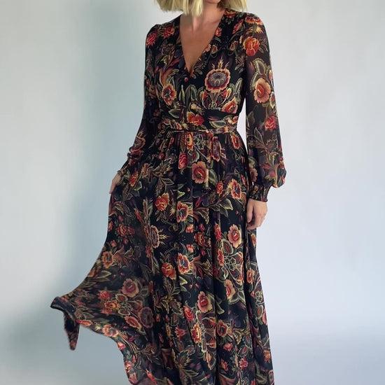 Hera Maxi Dress in Black Multi Print with deep V-neckline, long sleeves, gathered waist, and smocked back.