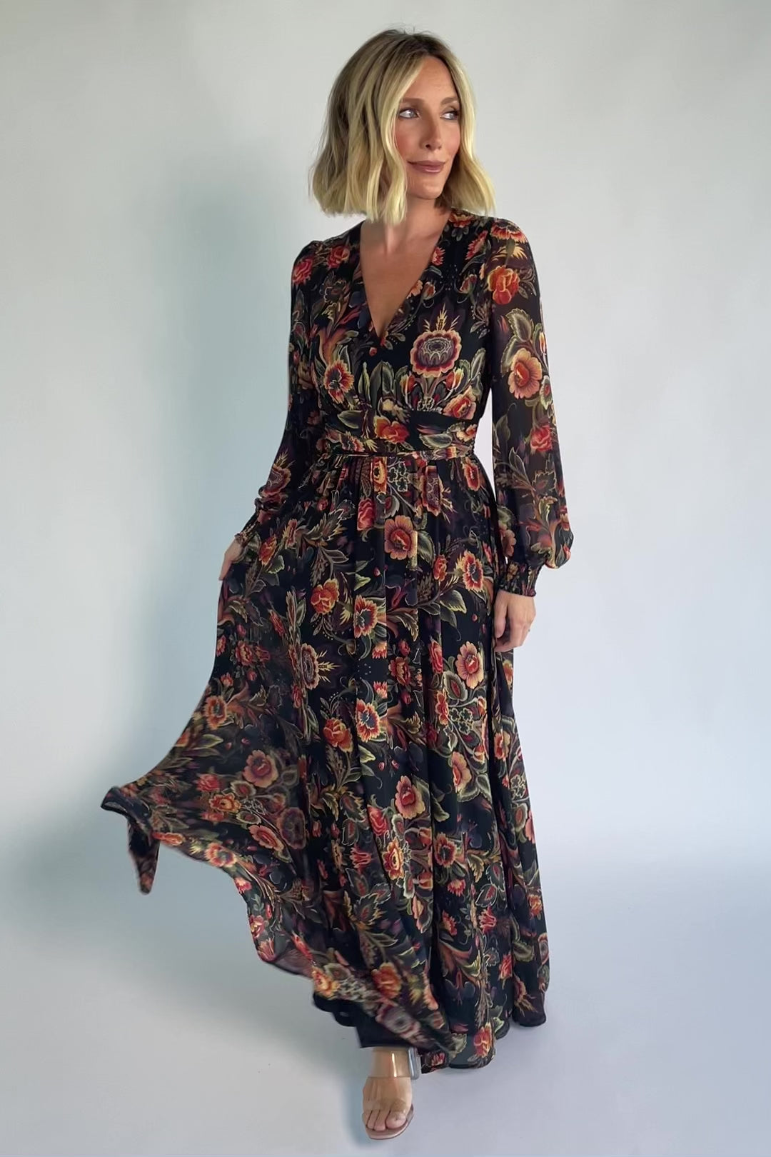 Hera Maxi Dress in Black Multi Print with deep V-neckline, long sleeves, gathered waist, and smocked back.