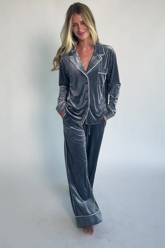 Dusty blue ribbed velvet pajama set with a collared button-front top, chest pocket, long sleeves, and wide-leg pants with an elastic drawstring waist and side pockets.
