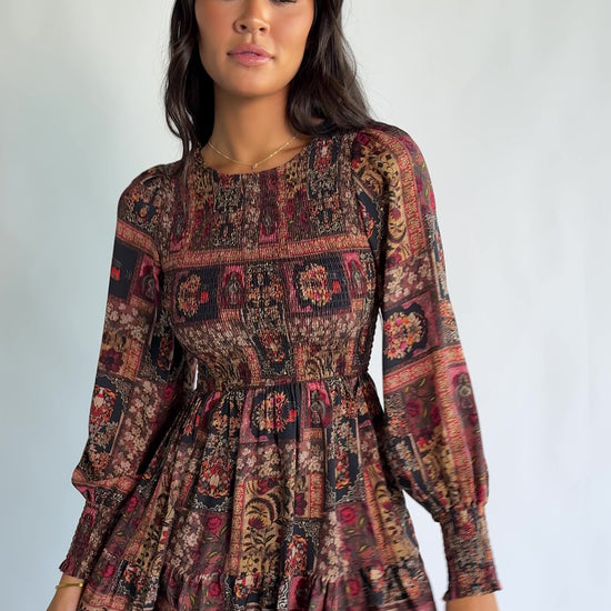 Nikki Smocked Midi Dress in Multi Print with a round neckline, smocked bodice, smocked cuffs, and a tiered skirt.