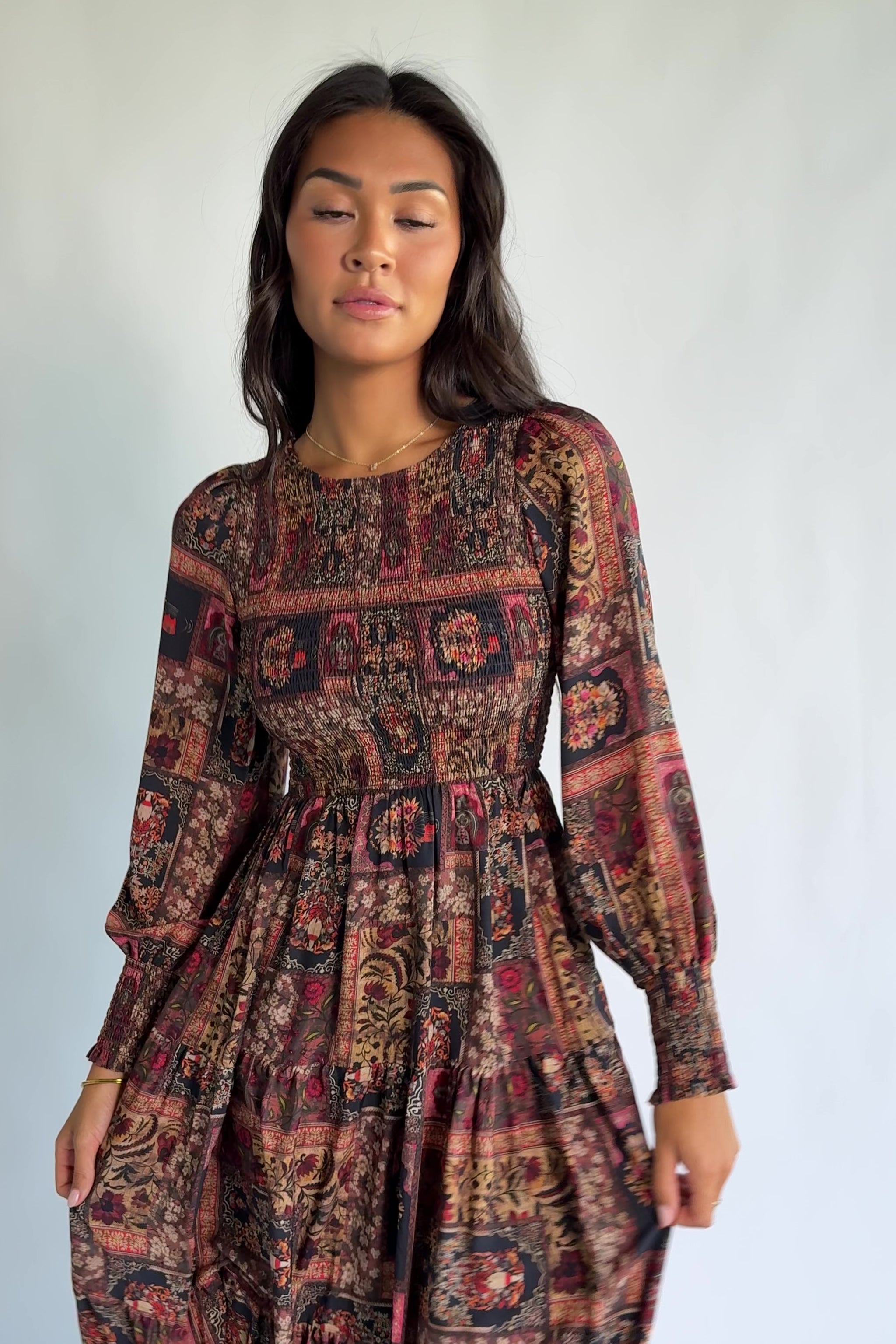 Nikki Smocked Midi Dress in Multi Print with a round neckline, smocked bodice, smocked cuffs, and a tiered skirt.