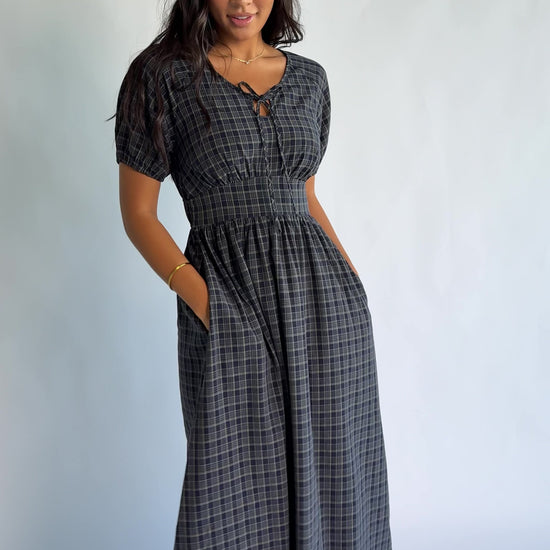 Rosalyn Midi Dress in Navy Plaid with V-neckline, adjustable bust tie, underbust panel, and midi skirt.