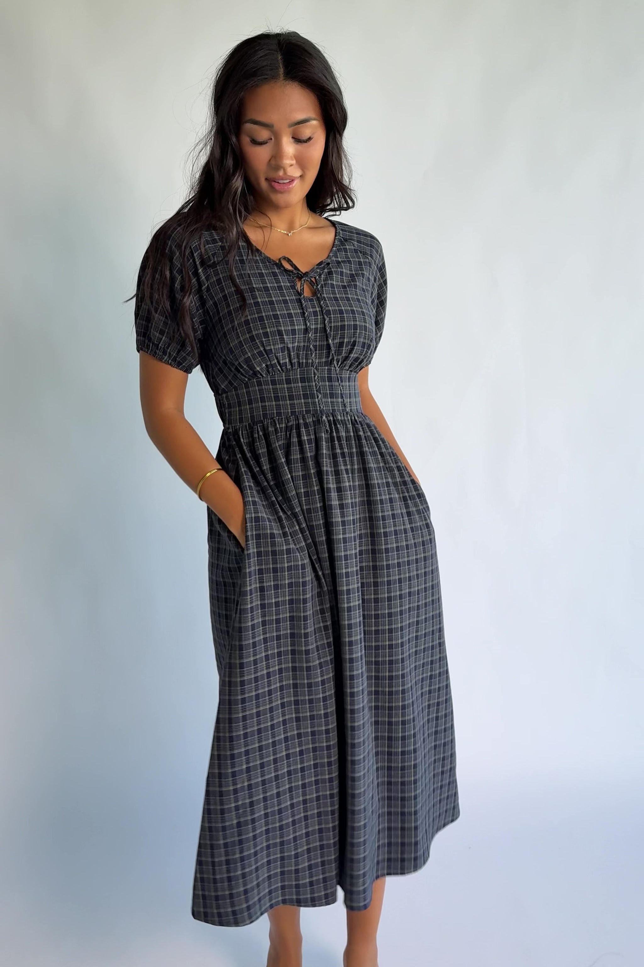 Rosalyn Midi Dress in Navy Plaid with V-neckline, adjustable bust tie, underbust panel, and midi skirt.