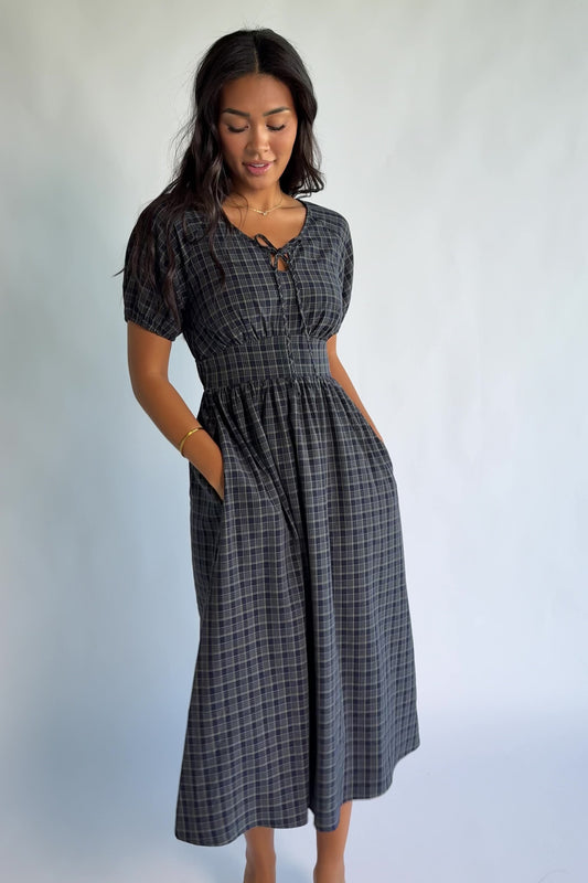 Rosalyn Midi Dress in Navy Plaid with V-neckline, adjustable bust tie, underbust panel, and midi skirt.