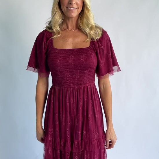 Auden Lace Midi Dress in Wine with square neckline, smocked bodice, and ruffle tiered skirt.