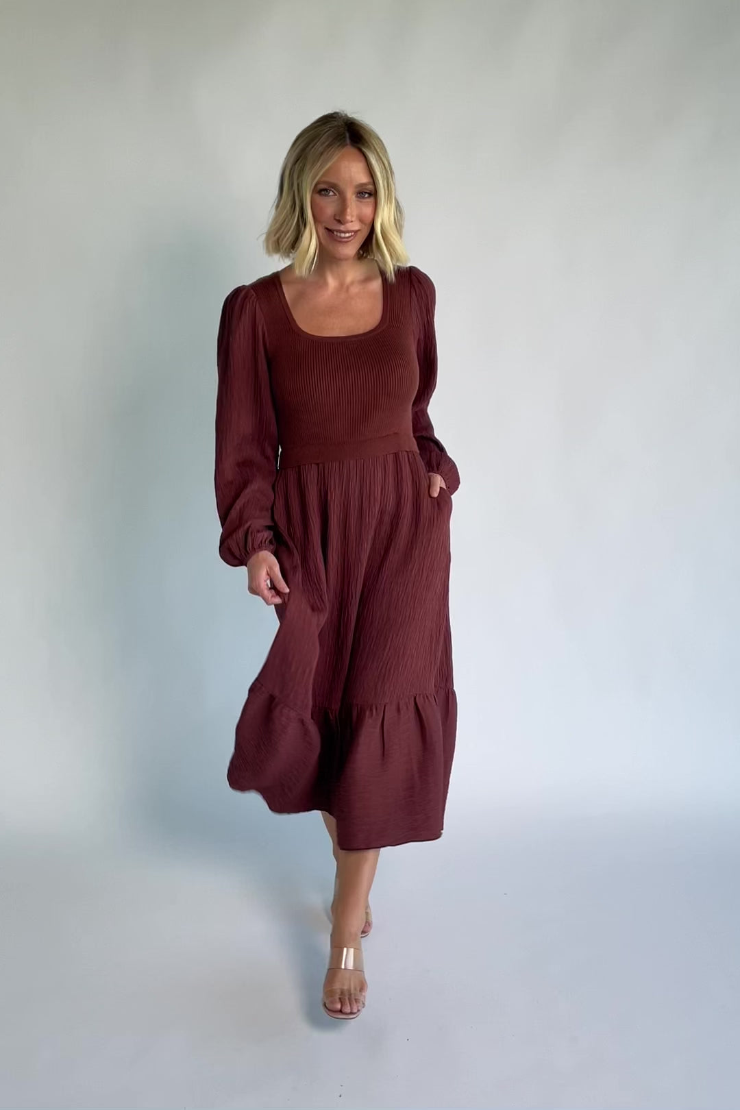 Alva Sweater Dress in Dusty Mahogany with ribbed knit bodice, square neckline, ruffle shoulders, long sleeves, and midi skirt.