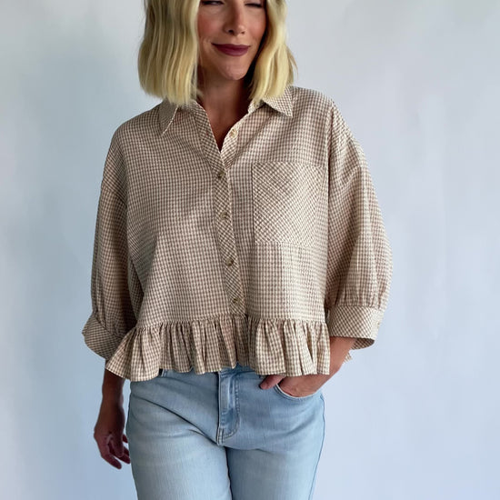 Murphy Relaxed Peplum Top in Beige with a collared neckline, button-front closure, chest pocket, and peplum hem.