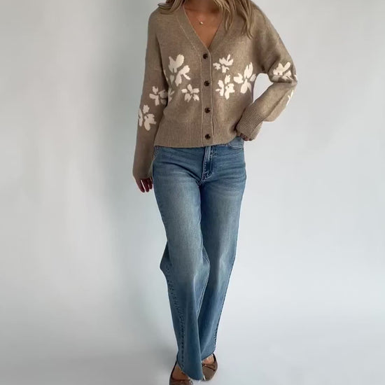 Taupe floral knit cardigan with a V-neckline, button-front closure, long sleeves, ribbed trim, and a relaxed silhouette.