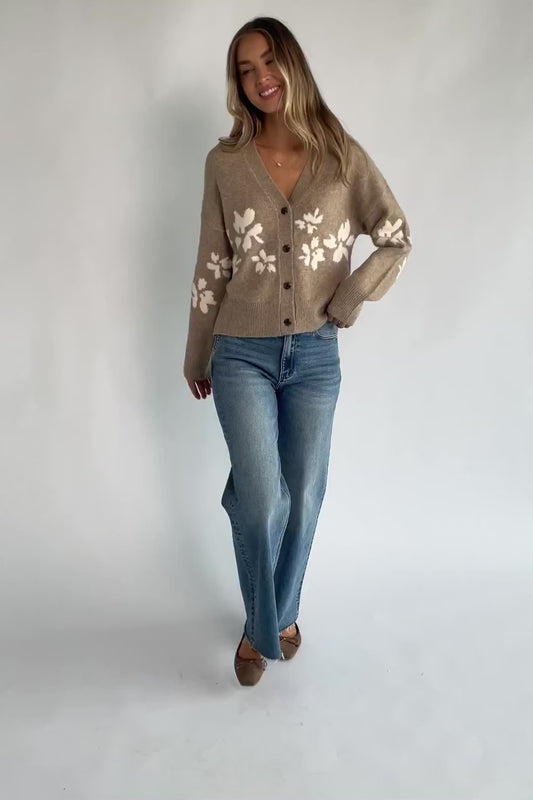 Taupe floral knit cardigan with a V-neckline, button-front closure, long sleeves, ribbed trim, and a relaxed silhouette.