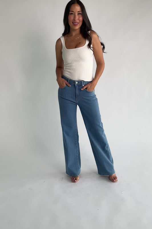 Vesper Mid Rise Wide Leg Jeans in Mid Wash with relaxed wide legs, mid-rise waist, button and zipper closure.