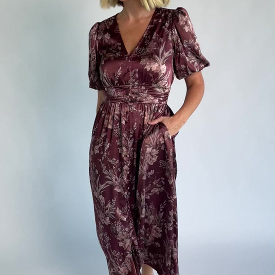 Lilibet Satin Dress in Clove Floral with V-neckline, short sleeves, faux front buttons, gathered waist, and satin finish.