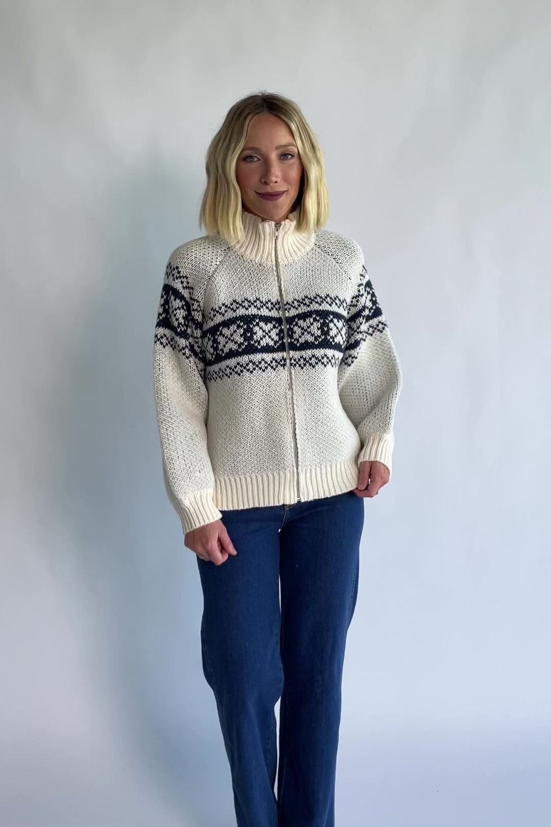 Neve Sweater Jacket in Cream + Navy with a Fair Isle knit pattern, turtleneck, silver zip-front design, and cozy thick knit.