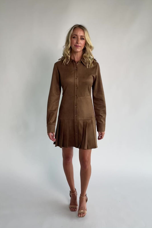 Coffee faux suede mini dress with a collared neckline, button-front closure, long sleeves, fitted waist, and pleated skirt.