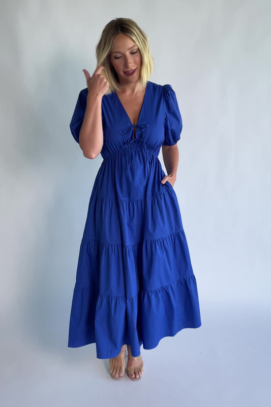 Sheila Tiered Midi Dress in Cobalt with V-neckline, front ties, puff sleeves, smocked empire waist, and tiered skirt.