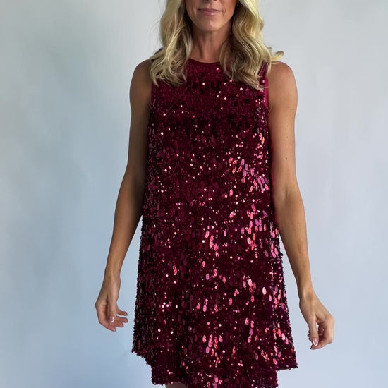Jolene Sequin Short Dress in Wine with allover sequin detailing, a sleeveless silhouette, and a round neckline.