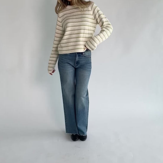 Cream and sage striped open-knit sweater with a round neckline, long sleeves, rolled trim, and a relaxed fit.