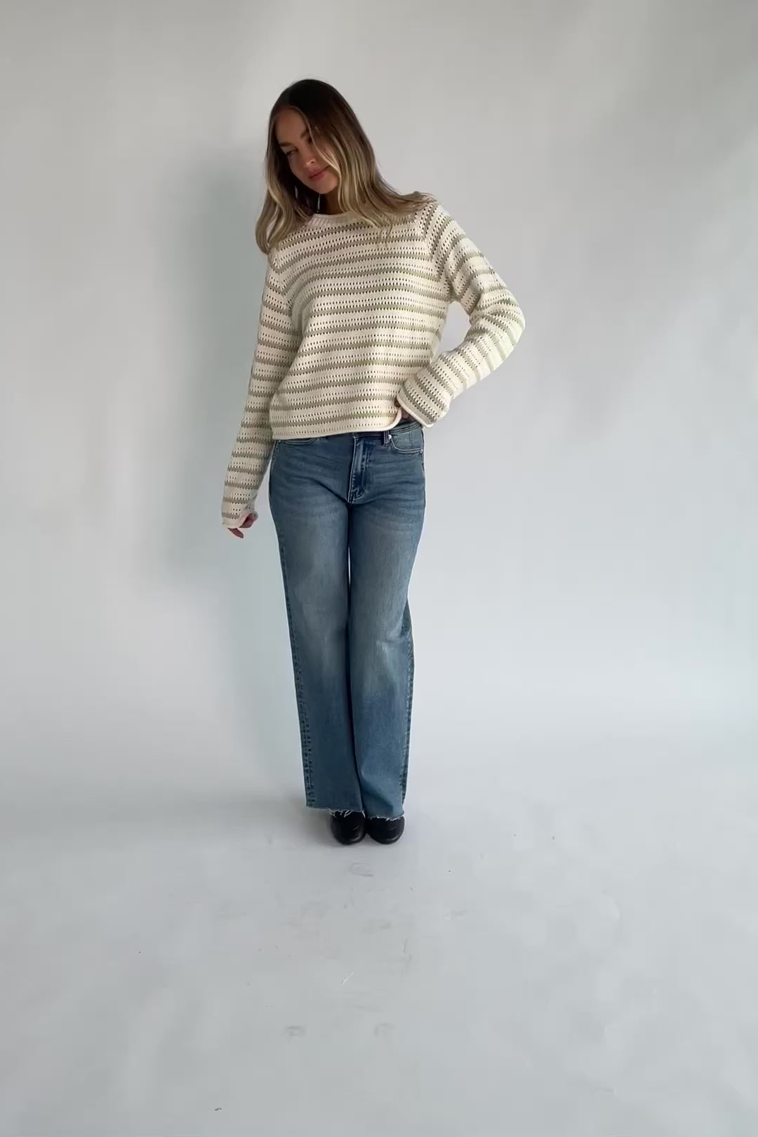 Cream and sage striped open-knit sweater with a round neckline, long sleeves, rolled trim, and a relaxed fit.