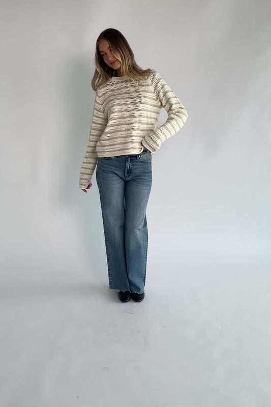 Cream and sage striped open-knit sweater with a round neckline, long sleeves, rolled trim, and a relaxed fit.
