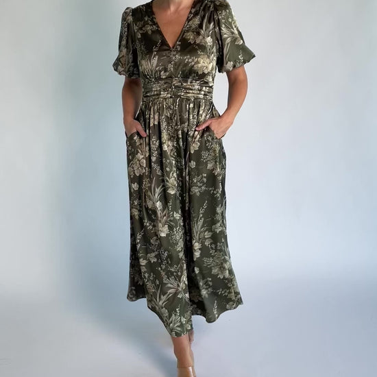 Lilibet Satin Dress in Olive Floral with V-neckline, short sleeves, faux front buttons, gathered waist, and satin finish.