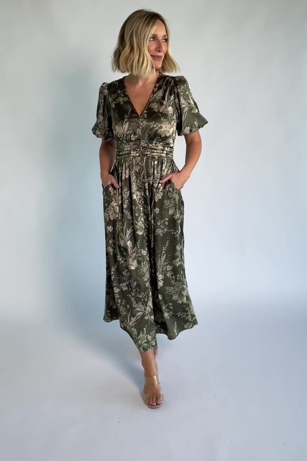 Lilibet Satin Dress in Olive Floral with V-neckline, short sleeves, faux front buttons, gathered waist, and satin finish.
