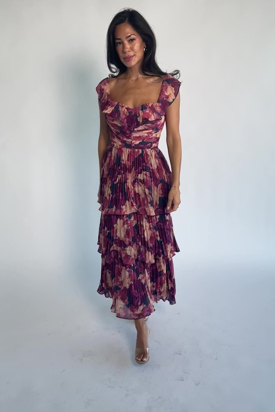 Model wearing the Steinway Pleated Midi Dress in Berry Floral featuring a pink, berry, and mauve floral print on lightweight pleated chiffon.