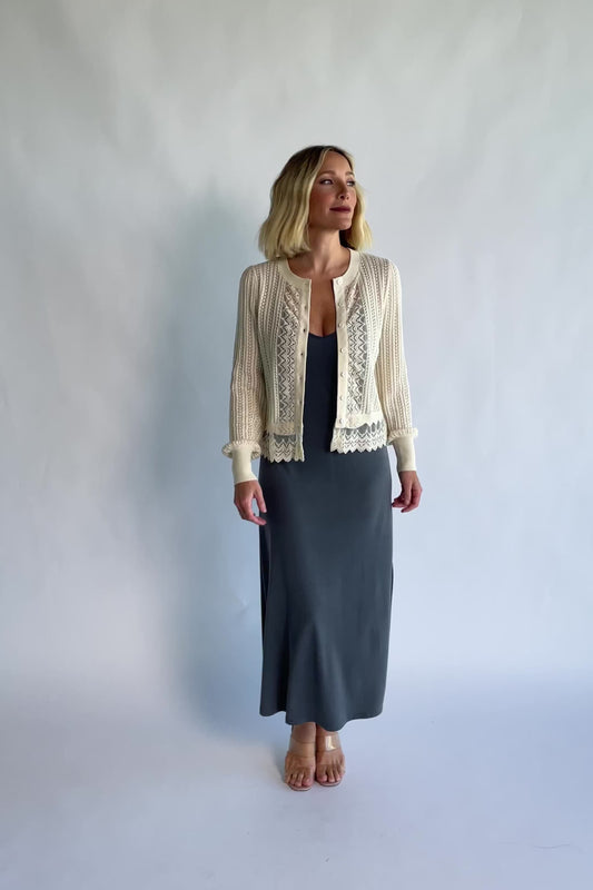 Bethany Pointelle Cardigan in Cream with pointelle knit detailing, a button-front design, and scalloped trim.