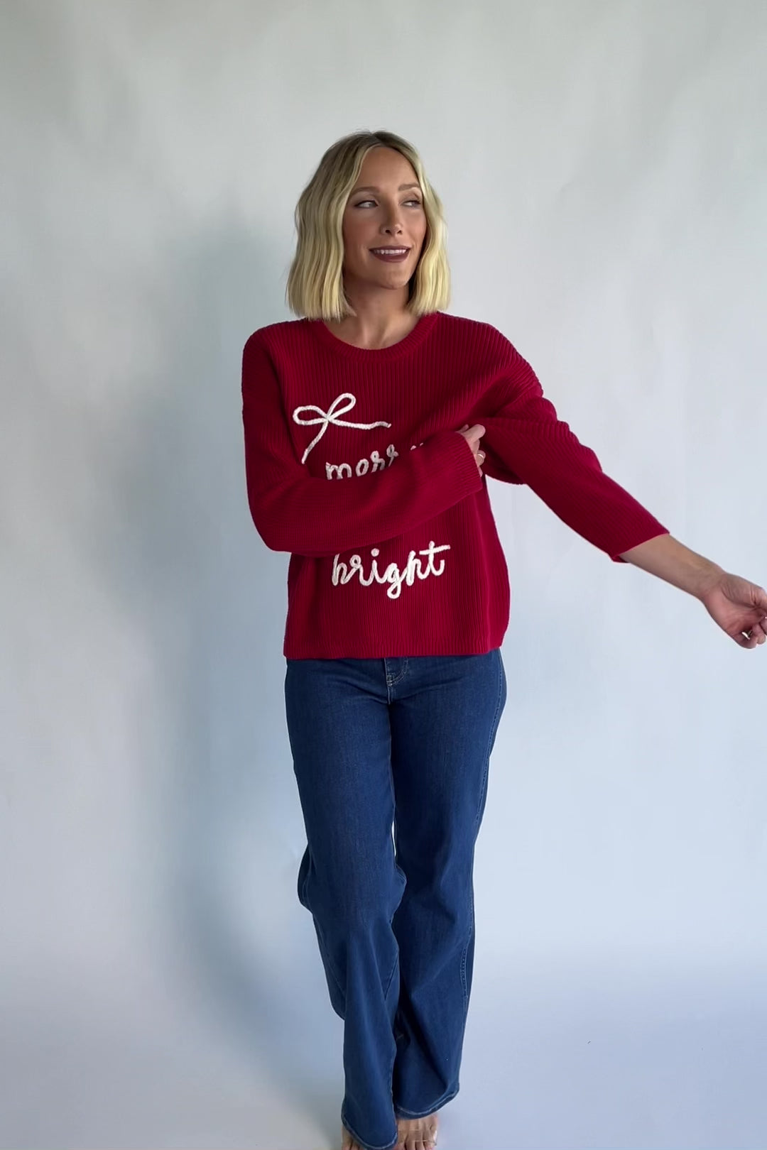 Merry Sweater in Red + Off White with a crew neckline, soft knit fabric, and embroidered Merry & Bright graphic.