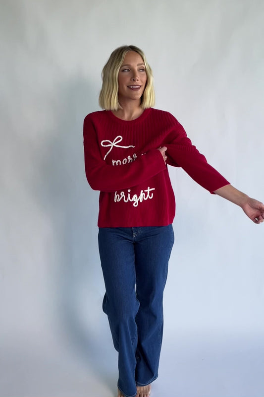 Merry Sweater in Red + Off White with a crew neckline, soft knit fabric, and embroidered Merry & Bright graphic.