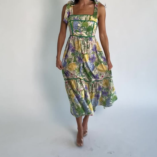 Model wearing the Torres Midi Dress featuring a multicolor floral print with green accents.